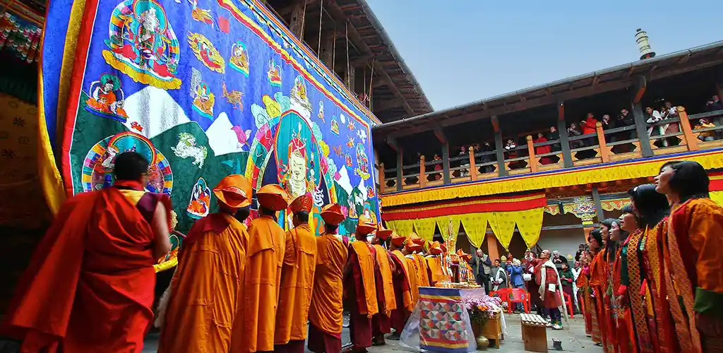 Monks unfurling of the thangka tapestry at a Jakar festival in Bhutan