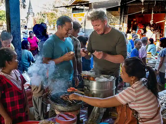 Gordon Ramsey tasting food at local market in Cambodia