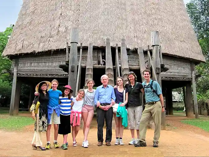 Family in front of hilltribe longhouse in North Vietnam