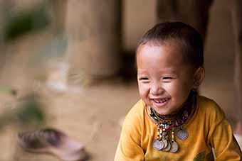 Vietnamese child smiling in Hue, Vietnam by Mark Tuschman