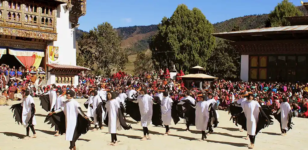 Children in costume dancing at the annual Black-necked-crane festival in Bhutan