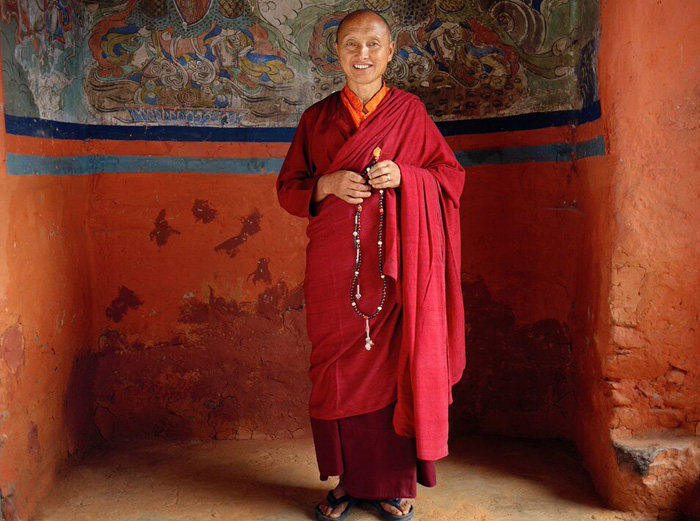 Photograph of monk in Bhutan monastery by Mark Tuschman