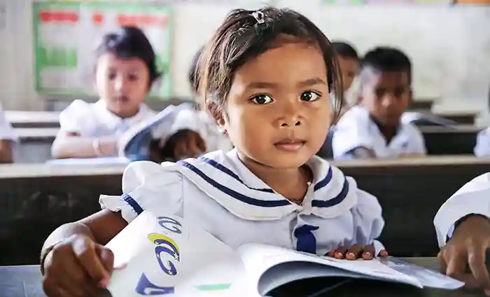Child learning to read in classroom in Cambodia