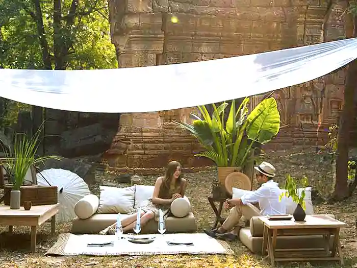 Couple-in-luxury-safari camp in the Angkor temple complex, Cambodia