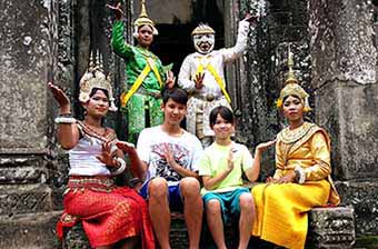 Family with traditional dancers at Angkor Wat