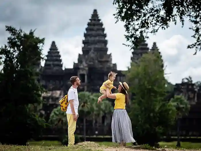Family photographed in front of Angkor Wat Cambodia by Photographer Regis Bernard