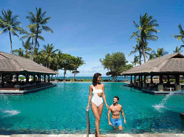 Honeymoon couple at resort pool in Bali, Indonesia