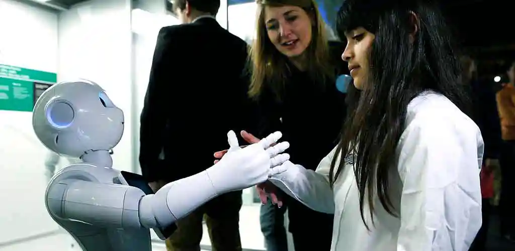 Child shaking hands with robot in Tokyo, Japan