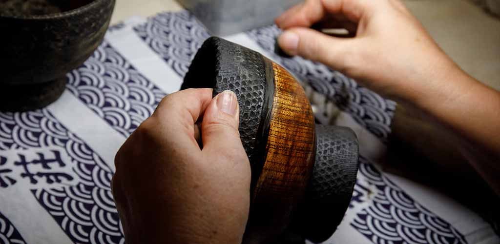 Japanese master pottery craftsman working on cup