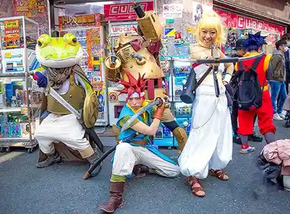 Cosplay characters posing in Den Den Town sidewalk, Osaka