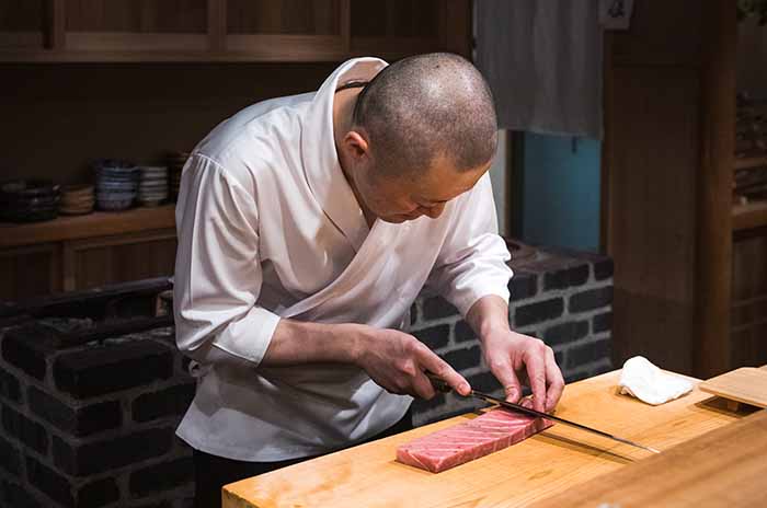 Tokyo chef at Amamoto preparing sashimi