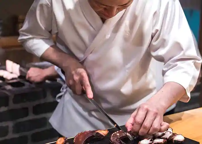 Chef Amamoto carving at sushi bar in Tokyo, Japan