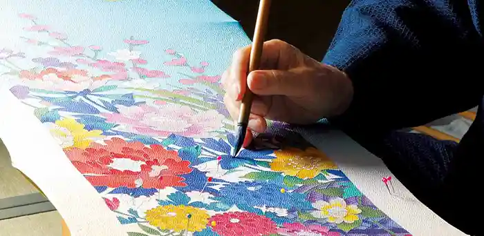 Artist hand dyeing silk in Ishikawa studio, Japan