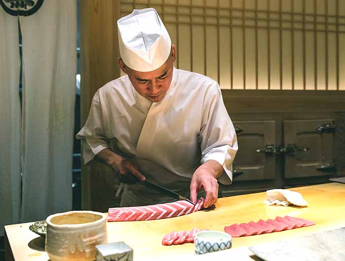 Sushi Saito chef cutting sashimi