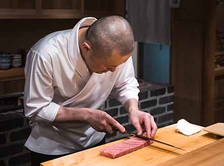 Chef at Higashiazabu Amamoto preparing a sashimi in Tokyo, Japan