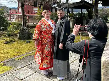 Honeymoon couple posing at at temple in Kyoto, Japan