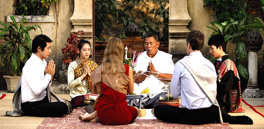 Blessing ritual for honeymoon couple in Luang Prabang, Laos