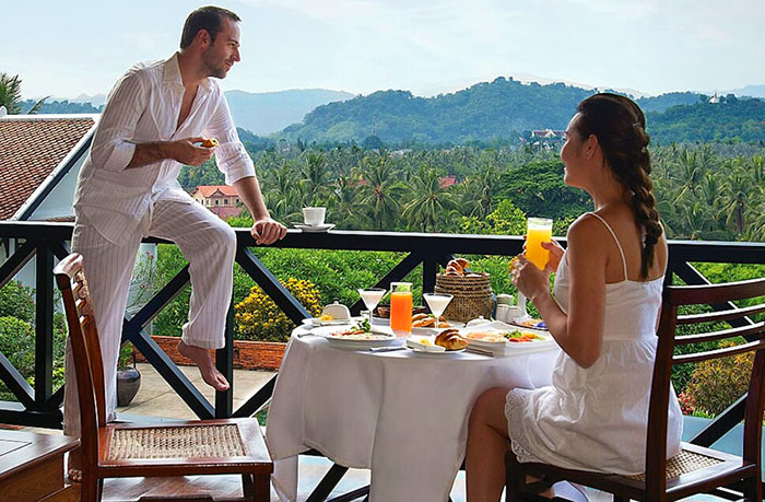 Romantic couple on terrace of La Residence luxury hotel in Luang Prabang, Laos