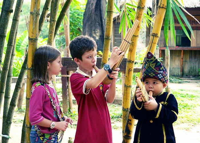 Children visting local children in Borneo tribal village