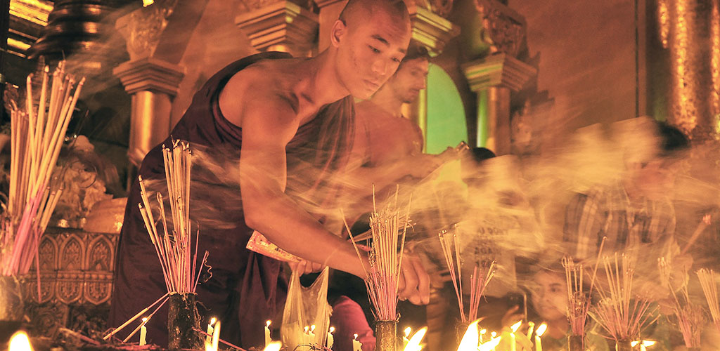 Monk lighting candles at festival in Myanmar