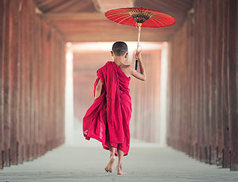 Young monk walking in Mandalay monastery, Myanmar