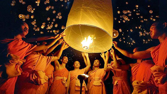 Monks lighting lanterns during Myanmar Festival of Lights