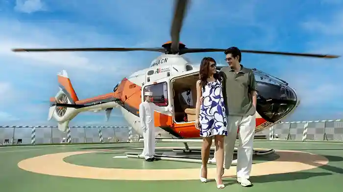 Couple arriving by helicopter to Peninsula Hotel in Bangkok