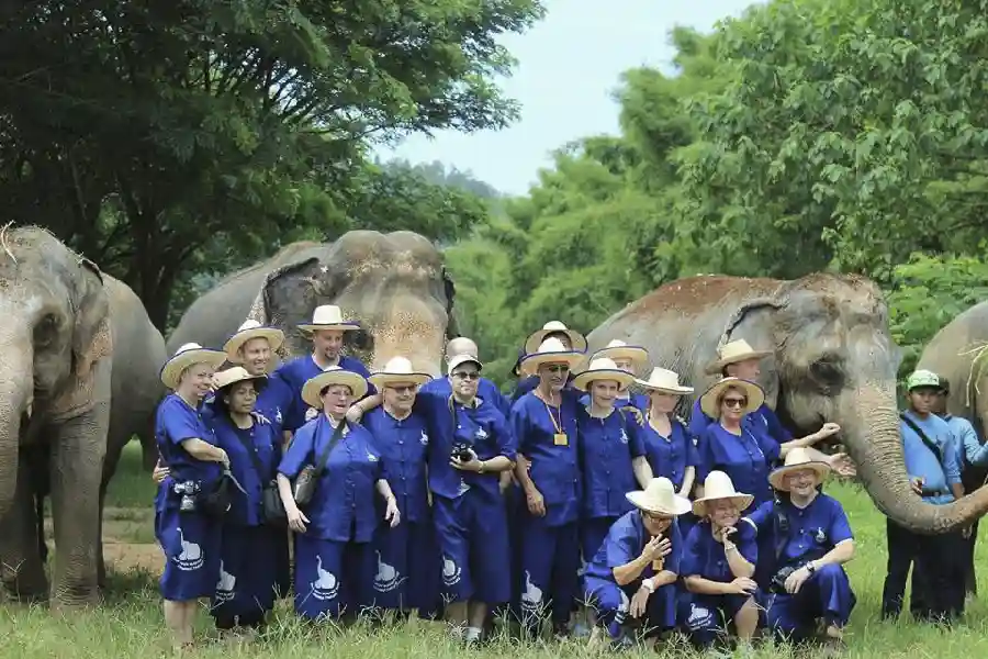 Visitors posing at Baan Chang elephant camp in Thailand