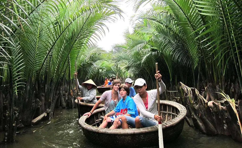 Family enjoying bamboo boat ride in Vietnam