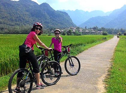 Family cycling in Ninh Binh, Vietnam