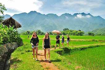 Family of travelers hiking around Mai Chau