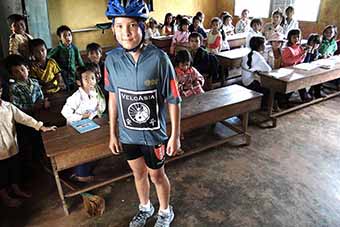 Child visiting classroom during a family cycling tour of Vietnam