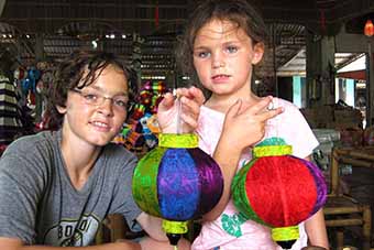 Child travelers learning to make lanterns in Hoi An Vietnam