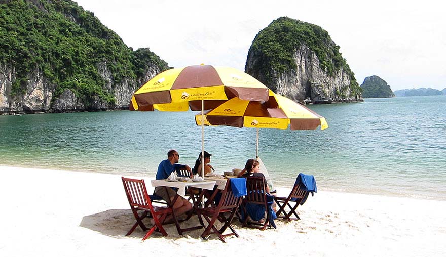 Private dining on a  beach in Halong Bay during a family tour