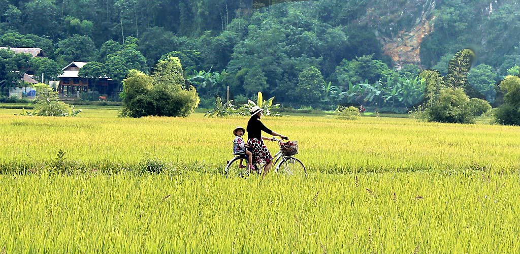 Mother and child cycling in Mai Chau, Vietnam