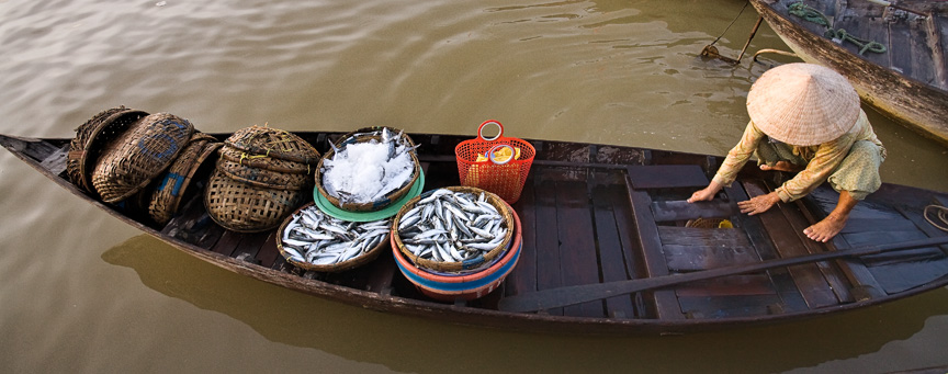 Fish monger on Halong Bay, Vietnam by Mark Tuschman